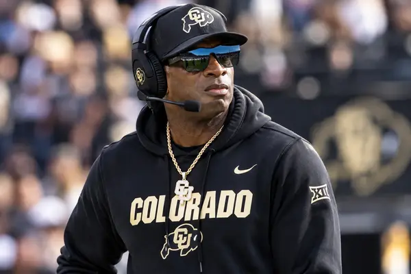 Deion Sanders on the football sideline wearing Colorado gear